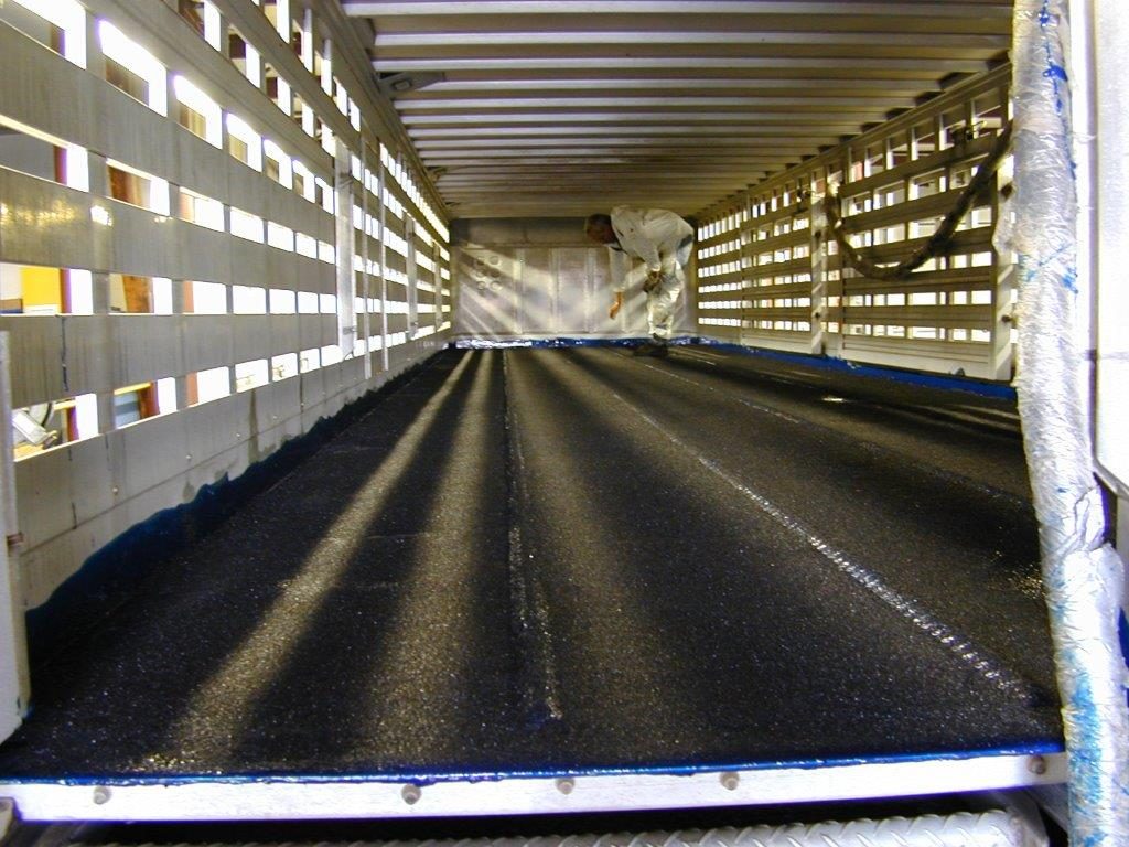 Trailer roof being coated with flexible polyurea membrane